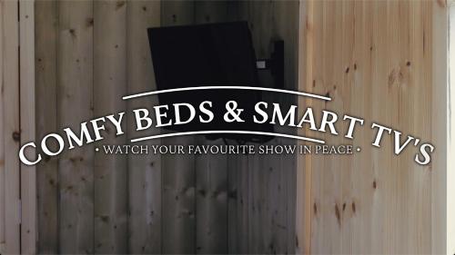 a sign for aney beds and smart tv on a wooden wall at Hot Tub Luxury Glamping - Private Stargazing Patio in Yarpole
