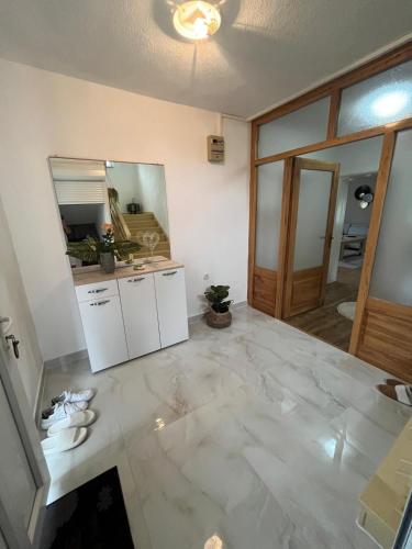 a living room with a marble floor and a mirror at Villa Pliva Oasis in Jezero