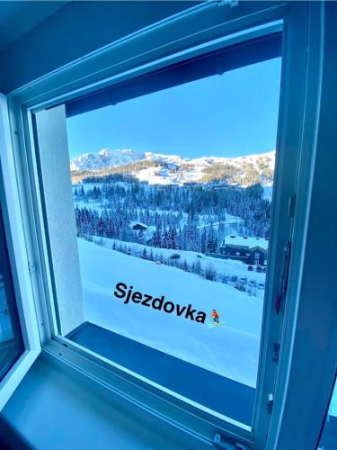 a window with the siegokka logo on it at Byt na svahu Sonnenalpe Nassfeld in Hermagor