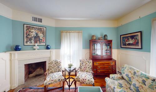 a living room with a fireplace and two chairs at The Red Lion Inn in Stockbridge
