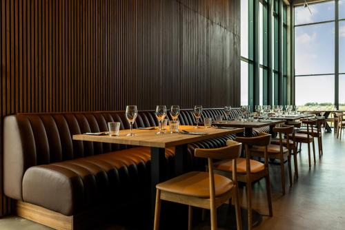 a row of tables and chairs with wine glasses at Hotel Loa in Hvolsvöllur
