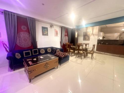 a living room with a couch and a table at Three Bed Premium Apartment in Islamabad