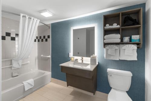 a bathroom with a tub and a sink and a toilet at Compass Cove in Myrtle Beach