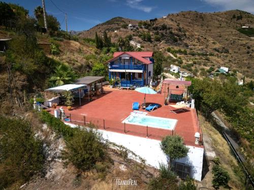 an aerial view of a house with a swimming pool at Chalet, breathtaking sea view with large jacuzzi in Almuñécar