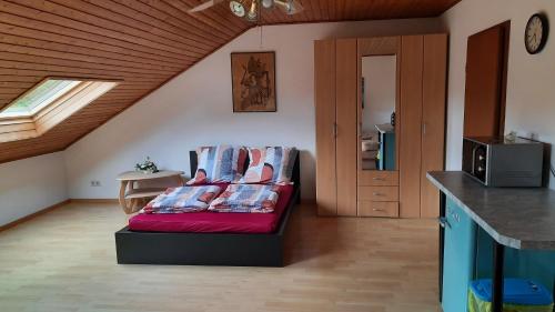 a living room with a red couch in a room at Wohnung am Rande der Nordeifel in Düren - Eifel