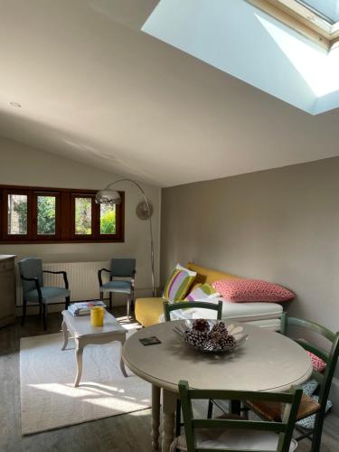 a living room with a couch and a table at Maison Revenu in Jalogny