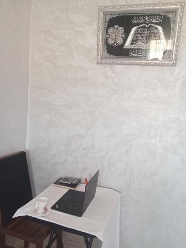 a table with a laptop computer on top of it at Résidence Al Qaraouiyine in Fès