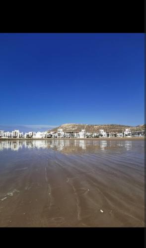 a large body of water with buildings in the background at Élégant Appartement de Standing à la Marina in Agadir
