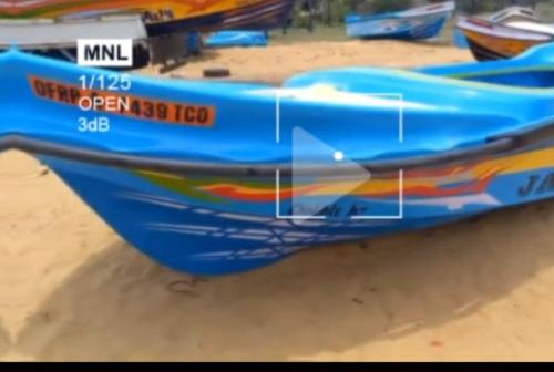 a blue boat sitting in the sand on a beach at Star Boad Ride in Trincomalee