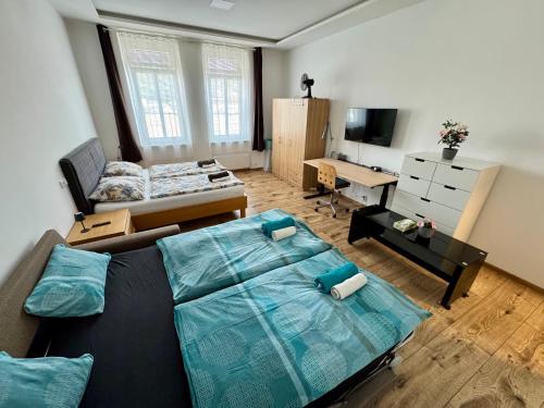 a living room with a bed and a desk at Apartment with Workspace and TV in Nový Lískovec