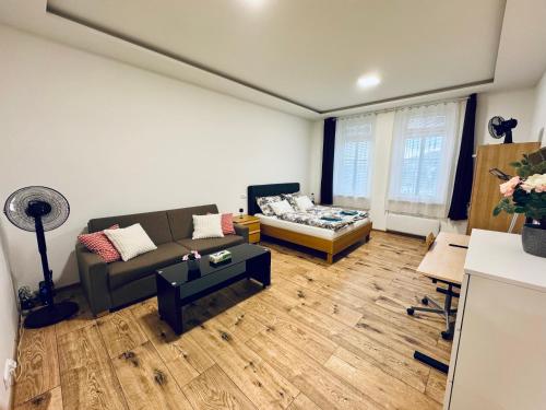 a living room with a couch and a table at Apartment with Workspace and TV in Nový Lískovec