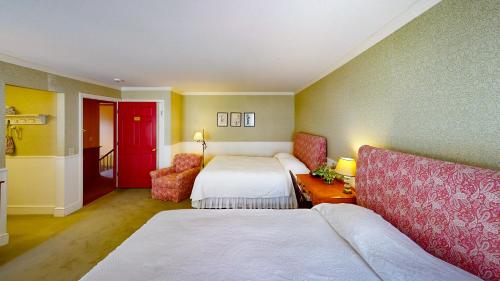 a hotel room with two beds and a couch at The Red Lion Inn in Stockbridge