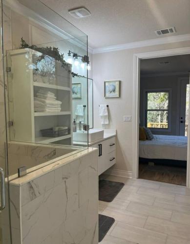 a bathroom with a sink and a mirror at Cozy Cottage Retreat in Nature in Cedar Creek