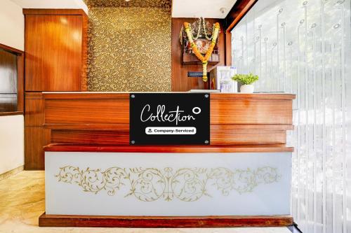 a restaurant with a sign on a counter at Super Collection O Airport Metro Andheri East in Mumbai