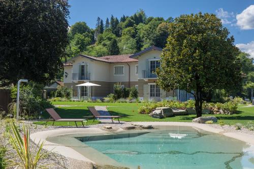 a house with a swimming pool in the yard at Villa Amelia in Orta San Giulio