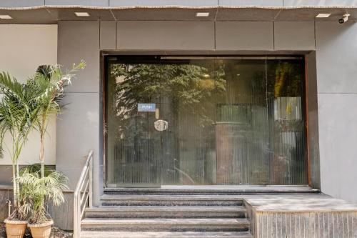 a glass door of a building with stairs at Super Collection O Airport Metro Andheri East in Mumbai