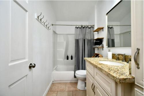a bathroom with a sink and a toilet and a shower at Cozy Cute Home 2BD and 1BR in Cypress