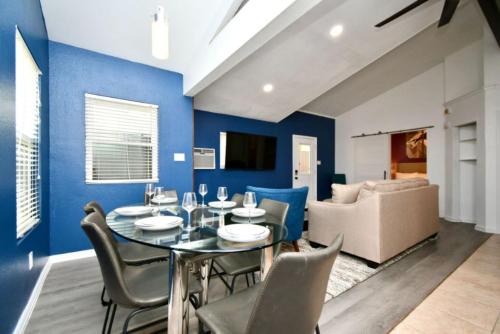 a dining room with blue walls and a table and chairs at Cozy Cute Home 2BD and 1BR in Cypress