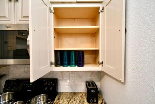 a kitchen cupboard with blue cups in it at Cozy Cute Home 2BD and 1BR in Cypress