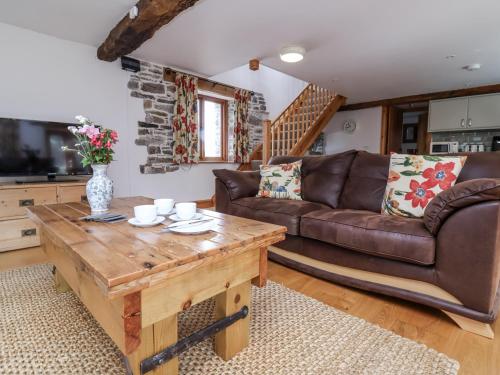 a living room with a couch and a coffee table at Lane End in South Molton