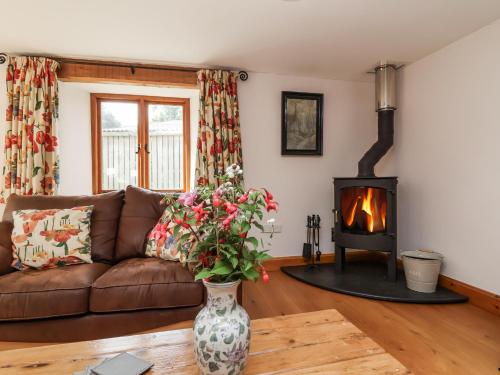 a living room with a couch and a fire place at Lane End in South Molton