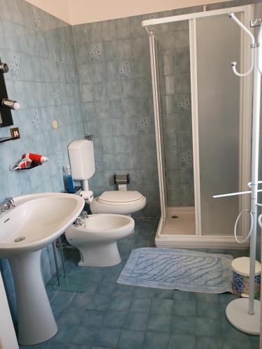 a bathroom with a toilet and a sink and a shower at Casa Vacanza Arzello in Melazzo