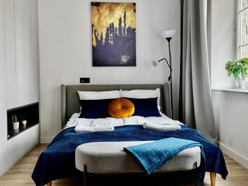 a bedroom with a bed with a blue blanket at Comfy Apartments - Old Town Center in Gdańsk