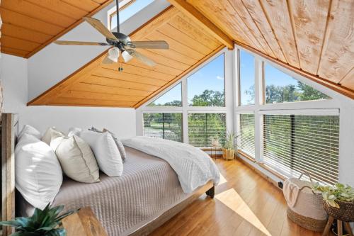 a bedroom with a bed with a ceiling fan at The Cozy Corner in Windermere Oaks on Lake Travis in Spicewood