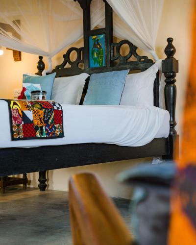 a bedroom with two bunk beds with white and blue pillows at Emerald Palm Boutique Hotel in Zanzibar City
