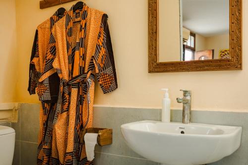a bathroom with a sink and a mirror at Emerald Palm Boutique Hotel in Zanzibar City