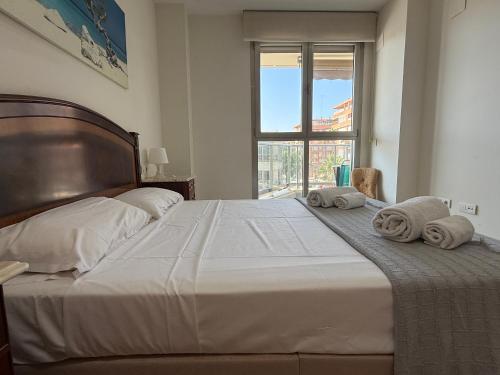 a bedroom with a large bed with towels on it at Reinapart Patacona Beachfront Seaview in Valencia