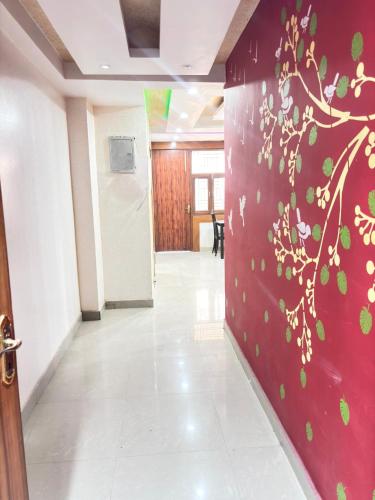 a hallway with a wall with a tree painted on it at Nivasa-Crafted with love in Ghaziabad