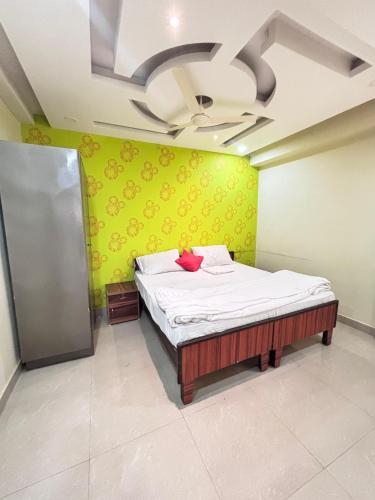 a bedroom with a bed and a ceiling fan at Nivasa-Crafted with love in Ghaziabad