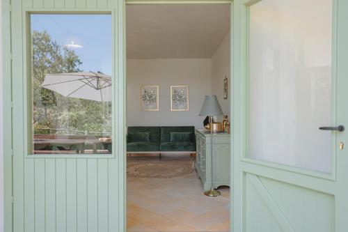 a door leading to a living room with a couch at Dimora delle Acque - Altavista Residence in San Nicola Arcella