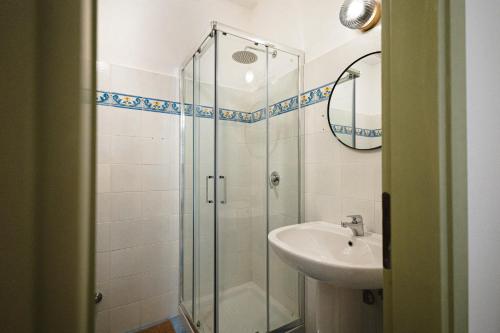 a bathroom with a glass shower and a sink at Dimora delle Acque - Altavista Residence in San Nicola Arcella
