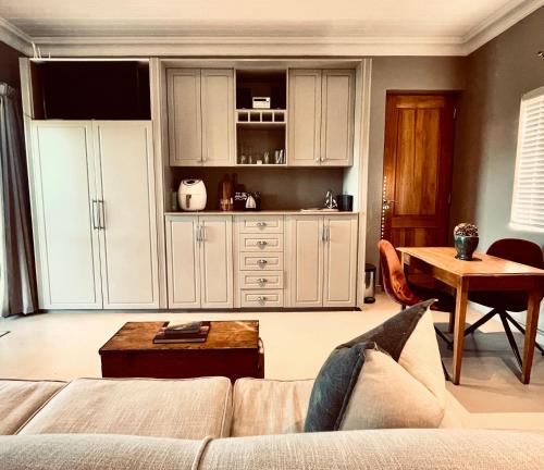 a living room with a couch and a table at Belle Vallee Guestroom 1 in Wellington