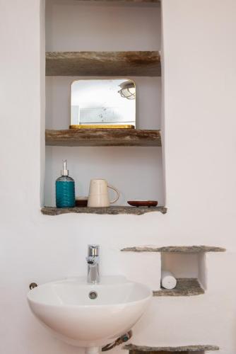 a bathroom with a sink and a mirror at Ceramic Lempesis House in Cherronisos