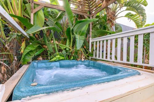 a hot tub sitting on top of a porch at בקתות בצל הגפן in Goren