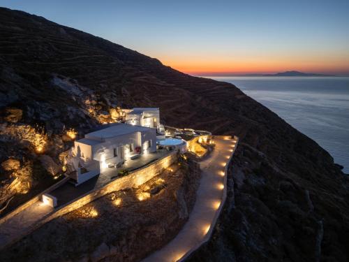 an aerial view of a building on a cliff with lights at CALDERA CASABLANCA in Ano Meria