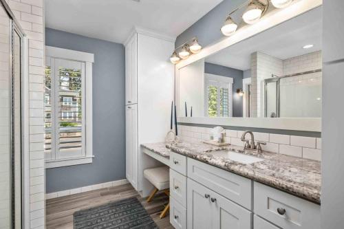 a bathroom with a sink and a mirror at Nauti Beach Cottage in Lincoln City