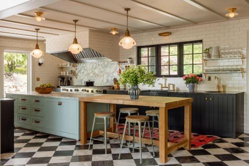 a kitchen with a large wooden island with bar stools at The Carly Estate in Carlton
