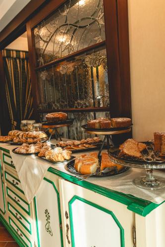 a buffet with many different types of pies and pastries at Hotel Petite Fleur in Roccaraso