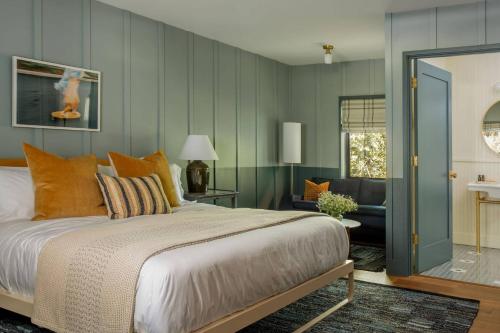 a bedroom with a large bed and a living room at The Carly Estate in Carlton