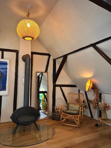 a room with a fireplace and a chair in it at Gemütliches Dachzimmer mit Kamin in Andernach