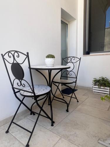 two chairs and a table on a patio at Eccelsoleccese Boutique B&B - steps from the Historic Center in Lecce