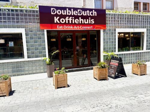 a restaurant with potted plants in front of a building at Seaview Beach Hotel in Philipsburg