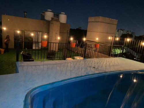 a swimming pool in front of a building at night at Devoto Hotel Boutique in Buenos Aires