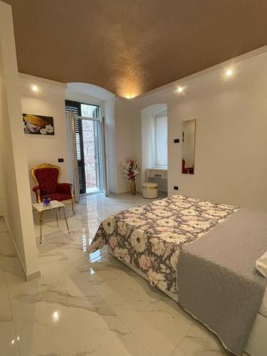 a large bedroom with a bed and a chair at Casa lumiére in Bisceglie