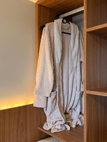 a towel is hanging in a closet at Parador Casa da Praia in Torres