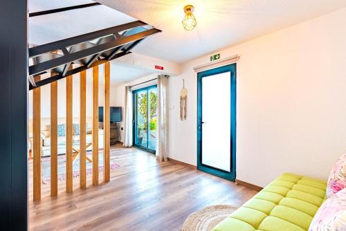 a living room with a couch and glass doors at Casa D'Avó Bela in Arco da Calheta